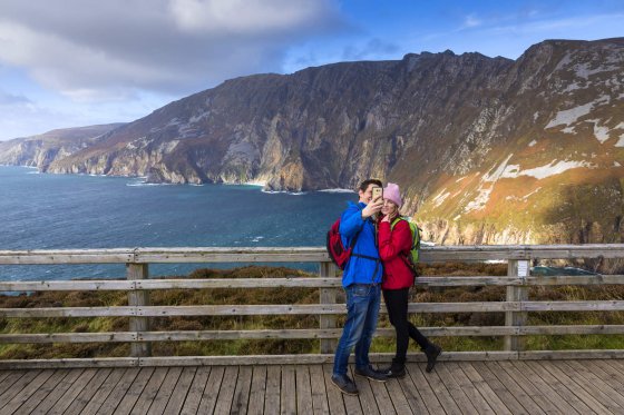 couple capturing image at Slieve League Mountains 